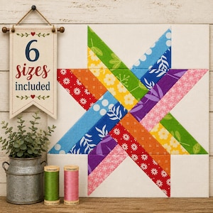Peut inclure: Un bloc de courtepointe carré en tissu avec un motif d'étoile multicolore aux imprimés floraux rouges, orange, jaunes, verts, bleus et violets. Une bannière suspendue affiche le texte 6 sizes included. Deux bobines de fil sont posées près d'un seau.
