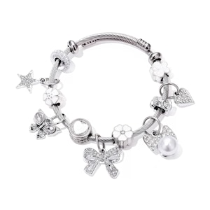 May include: Silver-toned charm bracelet with various decorative charms. Charms include a star, flowers, a butterfly, a heart, a bow, and a pearl. The bracelet is made of a twisted metal cable design.