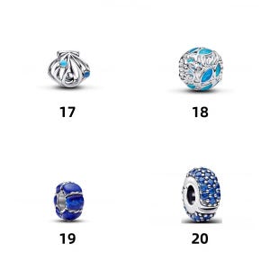 May include: Four silver charms labeled 17 through 20. Number 17 is a shell with blue accents. Number 18 is a spherical charm with blue leaf-like cutouts. Number 19 is a blue stone bead with silver wire wrapping. Number 20 is a silver bead with blue stones.