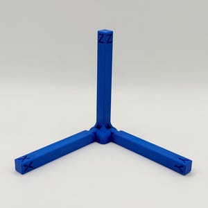 May include: A blue, three-legged stand with a central vertical support. The stand's legs are at 90-degree angles, each with an "X" or "Y" marking. The top of the central support has "ZZ" markings.