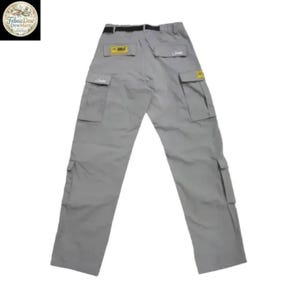 May include: Gray cargo pants with multiple pockets and a black belt. The pants have a relaxed fit and are made of a durable material. Small yellow and white labels are visible on the back pockets. The pants are laid flat on a white background.