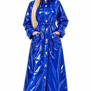 May include: A long, glossy royal blue raincoat featuring a hood, long sleeves, and a front button closure with gold-toned buttons. The coat includes a matching tie belt at the waist and two front pockets, crafted from a shiny, reflective material.