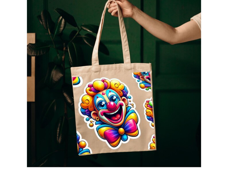 May include: A beige canvas tote bag featuring a repeating pattern of a colorful clown illustration. The clown has bright yellow, pink, and blue hair, a red nose, a wide smiling mouth, and a large, vibrant multi-colored bow tie at the neck.