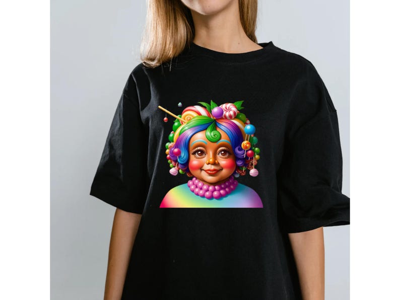 May include: A black short-sleeved t-shirt featuring a graphic print of a character with vibrant, multi-colored hair styled with various round candies and lollipops. The character wears a pink beaded necklace and a rainbow-colored shirt collar.