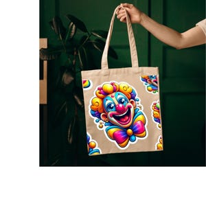 May include: A beige canvas tote bag featuring a repeating pattern of a colorful clown face with bright yellow hair, a red nose, blue accents, and a multi-colored bow tie. The design is printed in a vibrant, cartoon-style graphic on the fabric.