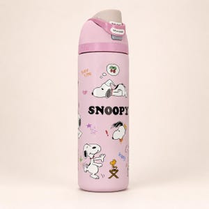 May include: A light pink water bottle featuring Snoopy graphics, the text "SNOOPY", "Sure sign", and "Lift to unlock" on the lid. The design includes illustrations of Snoopy in various poses, a small yellow bird, cherries, stars, and exclamation marks.
