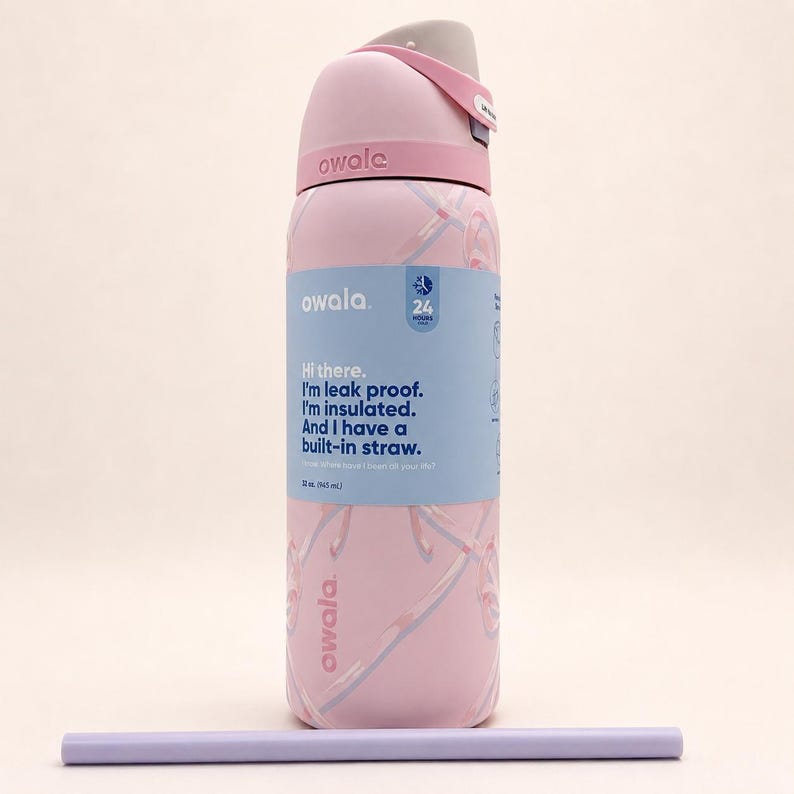 May include: A light pink Owala insulated water bottle with a 32 oz capacity, featuring a gray lid, a built-in straw, and a blue label with the text: Hi there. I'm leak proof. I'm insulated. And I have a built-in straw. A separate light purple straw lies below.