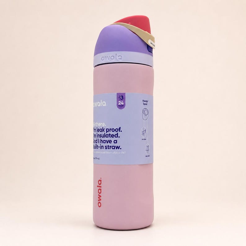May include: A light pink insulated water bottle with a purple lid and a red and beige flip-top cap. The bottle features a light purple paper label with the text: Hi there. I'm leak proof. I'm insulated. And I have a built-in straw. Owala branding.