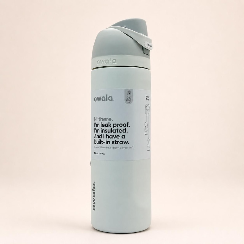 May include: A light blue Owala insulated water bottle with a gray lid and a built-in straw. The bottle features a white label with the text: Hi there. I'm leak proof. I'm insulated. And I have a built-in straw. It has a 24 oz capacity.