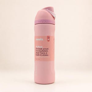 May include: A light pink insulated water bottle with a matching lid and a built-in straw. The label reads: Owala, Hi there. I'm leak proof. I'm insulated. And I have a built-in straw. 24 oz. (710 ml). The bottle features a carry loop and branding.