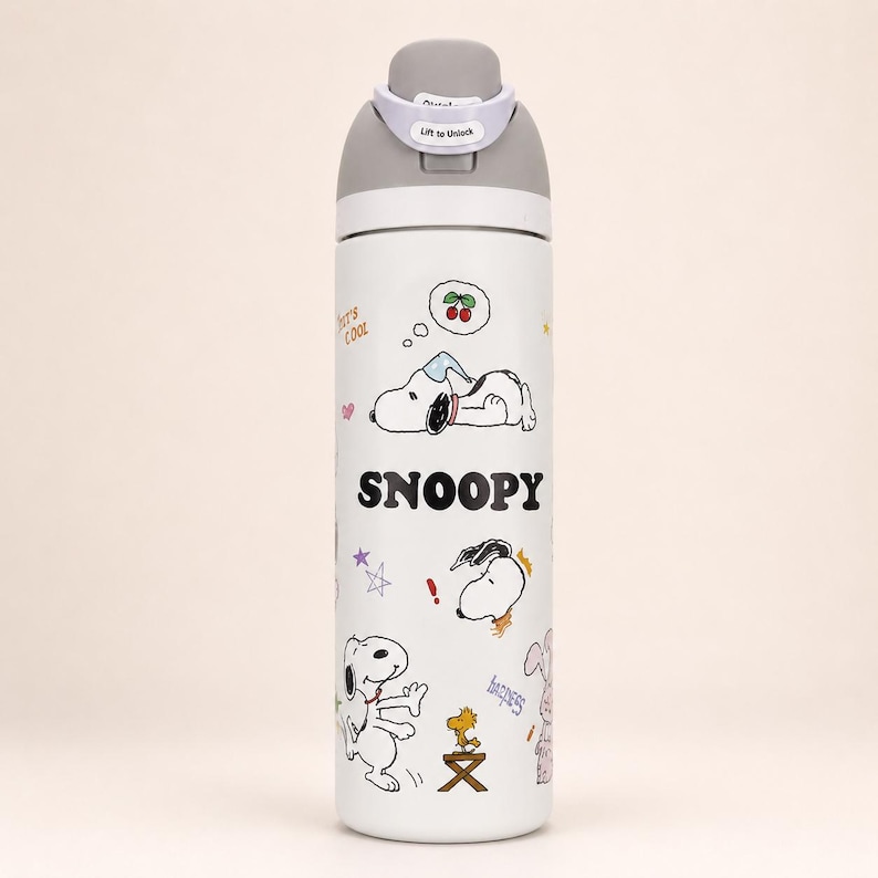 May include: A white stainless steel water bottle featuring Snoopy graphics, the text "SNOOPY", "It's COOL", and "happiness". The bottle has a gray lid with a white "Lift to Unlock" latch mechanism. The design includes illustrations of Snoopy sleeping, dancing, and Woodstock on a stool.