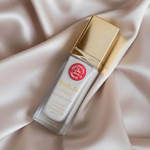 May include: A rectangular glass bottle of Alhalal London colour changing foundation with a gold cap. The label features the text Alhalal London by Mehwish Fatima, Colour Changing Foundation SPF 50, and a red Halal Monitoring Committee UK logo.