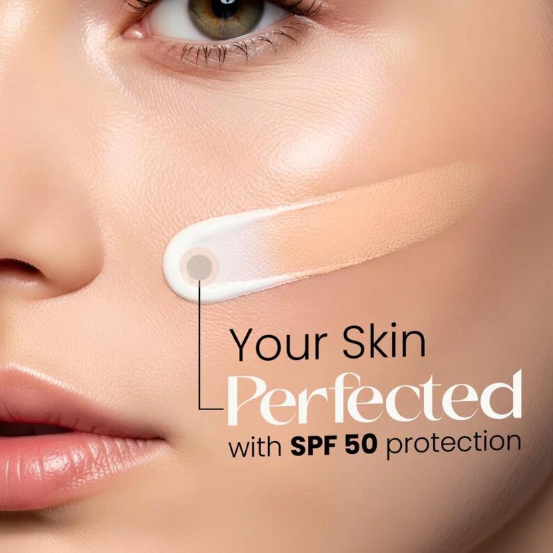 May include: A swatch of beige tinted cream applied to a cheek, showing a transition from white to a skin-toned shade. The text reads Your Skin Perfected with SPF 50 protection, highlighting the cosmetic product's coverage and sun protection.