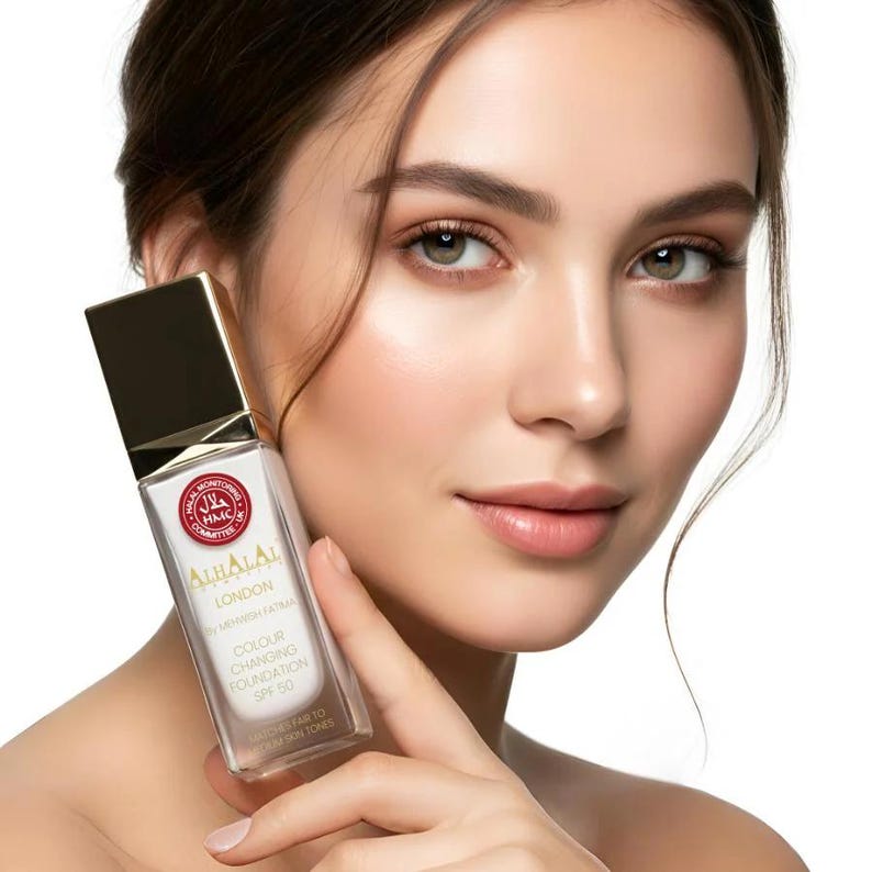 May include: A rectangular glass bottle of Alhalal London colour changing foundation with SPF 50. The bottle features a gold cap, a white label with red HMC Halal certification logo, and text stating it matches fair to medium skin tones.