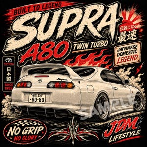 May include: A white Toyota Supra sports car graphic on a black background with red flames. Text includes BUILT TO LEGEND, SUPRA A80 TWIN TURBO, JAPANESE DOMESTIC LEGEND, NO GRIP NO GLORY, JDM LIFESTYLE, and Japanese characters with a Toyota logo.