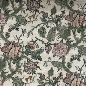 May include: A woven fabric featuring a dense botanical pattern with intricate floral motifs in shades of dusty pink, muted orange, and deep olive green. The design consists of interconnected vines, textured leaves, and blooming flowers on a cream background.