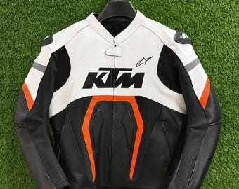 Chaqueta de moto KTM de cuero negro, blanco y naranja, estilo vintage, para motociclistas de carreras.