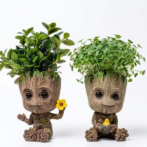 May include: Two brown tree-like planters with textured bark surfaces, each holding a green plant. The left planter features a small yellow flower, while the right planter holds a small yellow bird figurine nestled in a tiny gray nest.