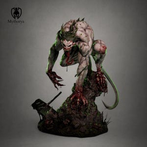 May include: A detailed figurine of a pale, muscular monster with sharp teeth, a long red tongue, and clawed hands stained red. The creature crouches on a dark, rocky base featuring small skulls and a black hammer, with the text Mythorya visible.