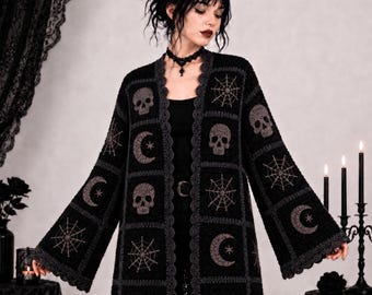 May include: A black crochet cardigan featuring a repeating pattern of skulls, spiderwebs, and crescent moons with stars. The garment has long, wide sleeves and a scalloped gray border along the front opening and hem, constructed from square motifs.