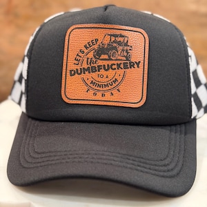 May include: Black trucker hat with a brown leather patch featuring a UTV graphic and the text "Let's Keep The Dumbfuckery To A Minimum Today." The hat has a black front and a white and black checkered pattern on the sides.