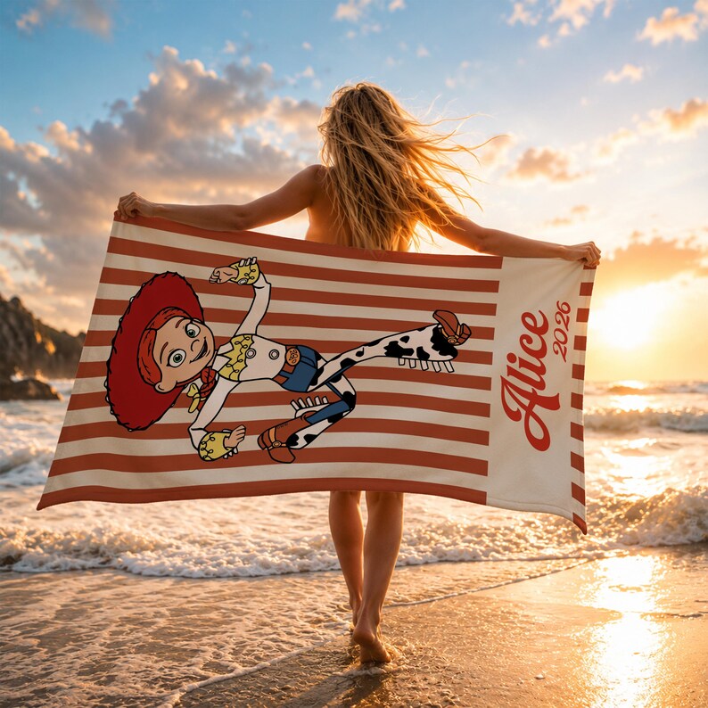 May include: A rectangular beach towel featuring a red and white striped pattern with a graphic of the character Jessie from Toy Story. The towel includes a white vertical panel on the right side with the printed text Alice 2026 in red script.