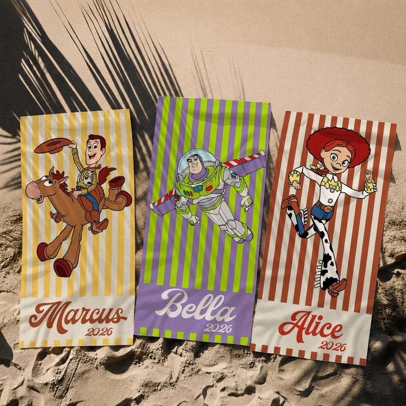 May include: Three rectangular beach towels featuring Toy Story characters. The left towel has yellow stripes, Woody on Bullseye, and the name Marcus 2026. The center towel has green stripes, Buzz Lightyear, and Bella 2026. The right towel has red stripes, Jessie, and Alice 2026.