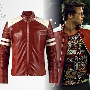 May include: A burgundy leather jacket with white accents on the shoulders and sleeves. The jacket has a zip-up front and a stand-up collar. The Enviro Jackets logo is in the upper left corner. The jacket is shown on a model.