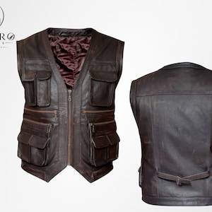 Può includere: Un gilet in pelle marrone con più tasche e una chiusura a zip frontale. Il gilet ha uno scollo a V e una fodera bordeaux scuro. Anche il retro del gilet è visibile, mostrando un design semplice con un dettaglio della cintura. Il logo Enviro Jackets è in alto a sinistra.
