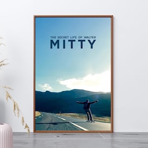 May include: A rectangular wall art print in a thin brown frame featuring a person longboarding on a paved road toward dark mountains under a bright sky. The text THE SECRET LIFE OF WALTER MITTY is printed in dark blue letters at the top center.