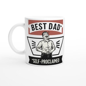 May include: White ceramic mug with the words "BEST DAD" in a red banner, and "*SELF-PROCLAIMED" in black text. The mug features a cartoon illustration of a man laughing. A perfect gift for Father's Day.