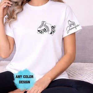 May include: White t-shirt with a black roller skate graphic on the front and a smaller skate and the name "Jennifer" on the sleeve. The text "ANY COLOR DESIGN" is also visible.