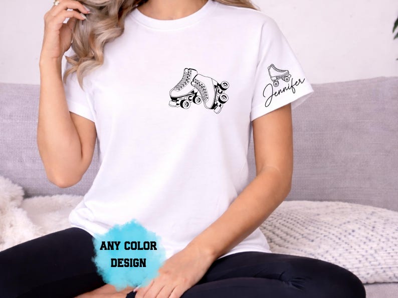 May include: White t-shirt with a black roller skate graphic on the front and a smaller skate and the name "Jennifer" on the sleeve. The text "ANY COLOR DESIGN" is also visible.
