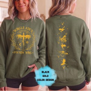 May include: Olive green sweatshirt with a gold graphic on the front that says "WINGLEADER" and "FOURTH WING". The back of the sweatshirt has a gold dragon design. The sweatshirt is a long-sleeved crew neck.