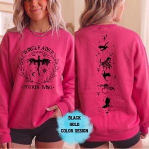 May include: Hot pink sweatshirt with a black dragon graphic on the front and back. The front features text that reads "WINGLEADER" and "FOURTH WING". The back has dragon silhouettes.