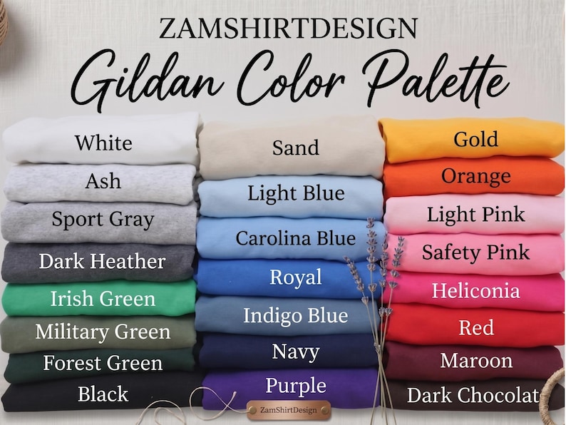 May include: A color palette chart from ZamShirtDesign, featuring a variety of Gildan colors. The image displays stacks of folded fabric in shades like white, ash, sport gray, dark heather, and various greens, blues, and pinks. The text "Gildan Color Palette" is at the top.