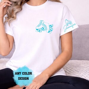 May include: White t-shirt with a teal roller skate design on the front and a smaller skate and the name "Jennifer" on the sleeve. The text "ANY COLOR DESIGN" is at the bottom of the shirt.