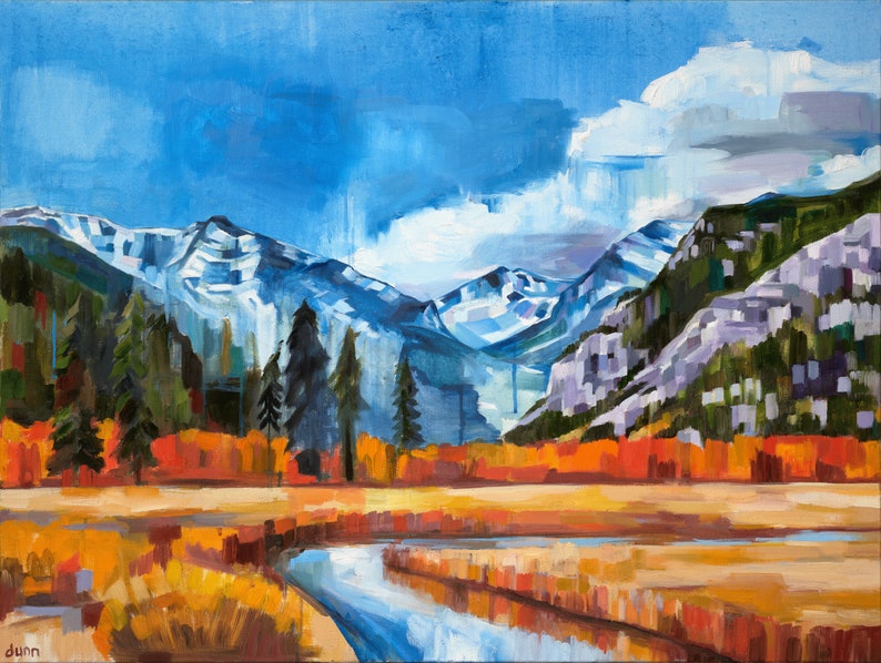 May include: A painting of a mountain landscape with a river flowing through a field of fall foliage. The mountains are snow-capped and the sky is blue with white clouds. The river is blue and the field is a mix of orange, yellow, and red.