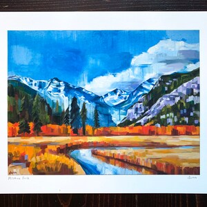 May include: A painting of a mountain landscape with a river flowing through a field of yellow grass. The mountains are snow-capped and the sky is blue with white clouds. The painting is signed "Dunn" in the bottom right corner and "Montana Park" in the bottom left corner.