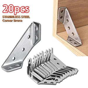 May include: A collection of 20 stainless steel corner braces. Each L-shaped bracket features pre-drilled holes for secure fitting. One bracket is shown fixed in a wooden corner. The text "20pcs" and "STAINLESS STEEL Corner Brace" is visible.