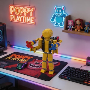 May include: A yellow and black Poppy Playtime character toy stands on a desk with a matching mousepad. The desk also features a keyboard, a computer, and neon signs that read "Poppy Playtime" and a blue monster.