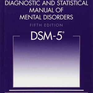 May include: A dark purple hardcover book titled Diagnostic and Statistical Manual of Mental Disorders Fifth Edition DSM-5 with white text and a central white-to-purple gradient rectangular frame, published by the American Psychiatric Association.
