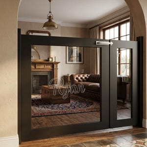 May include: Black interior doors with large glass panels, reflecting a room with a fireplace, leather sofa, and a patterned rug. The word "Ryan" is written on the glass. The doors are set in an arched doorway.
