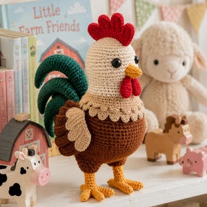 May include: A crochet rooster toy featuring a cream-colored head, a bright red comb and wattle, a dark brown body, light brown wings, and dark green tail feathers. The rooster has black bead eyes and yellow feet, standing upright on a surface.
