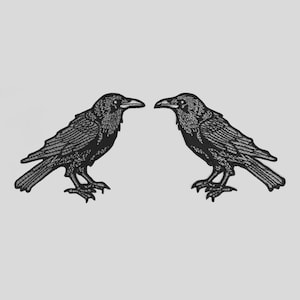 May include: Two black raven illustrations facing each other. The ravens are detailed with textured feathers and stand on small feet. The background is a solid, light gray color. The ravens are a gothic or Halloween theme.