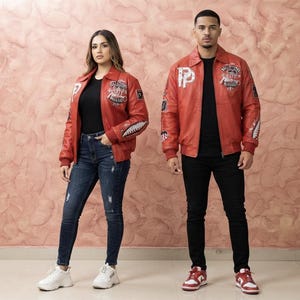 Könnte beinhalten: Eine rote Leder-Bomberjacke mit weißen und schwarzen Grafik-Aufnähern, klassischem Kragen, gerippten Bündchen und einem Frontreißverschluss. Die Jacke zeigt verschiedene gestickte Designs, einschließlich Text und Mustern auf Brust und Ärmeln.