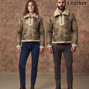 May include: Two individuals wearing matching brown distressed leather jackets with cream-colored shearling collars, cuffs, and hem linings. The jackets feature a half-zip front closure and two zippered pockets. The text Tanzie Leather is visible.