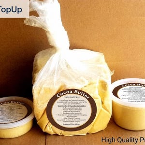 May include: The image showcases three containers of cocoa butter. A large, clear bag of cocoa butter is in the center, with two smaller containers on either side. The containers have labels with text. The words "OnTopUp" and "High Quality Product" are also visible.