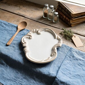 Cottagecore home decor dish displayed with pine branches and cookies