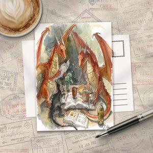 May include: Watercolor illustration of two orange dragons reading books at a table with a black cat. The scene includes drinks, a bottle, and a postcard. A cup of coffee is in the upper left corner. The background has passport stamps.